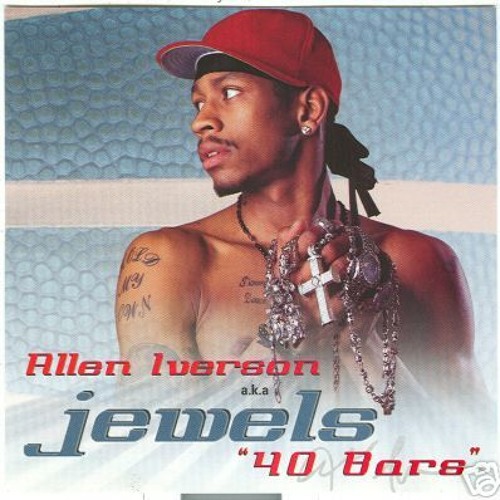 Allen Iverson shirtless and looking to the side with many chains and a hat on.